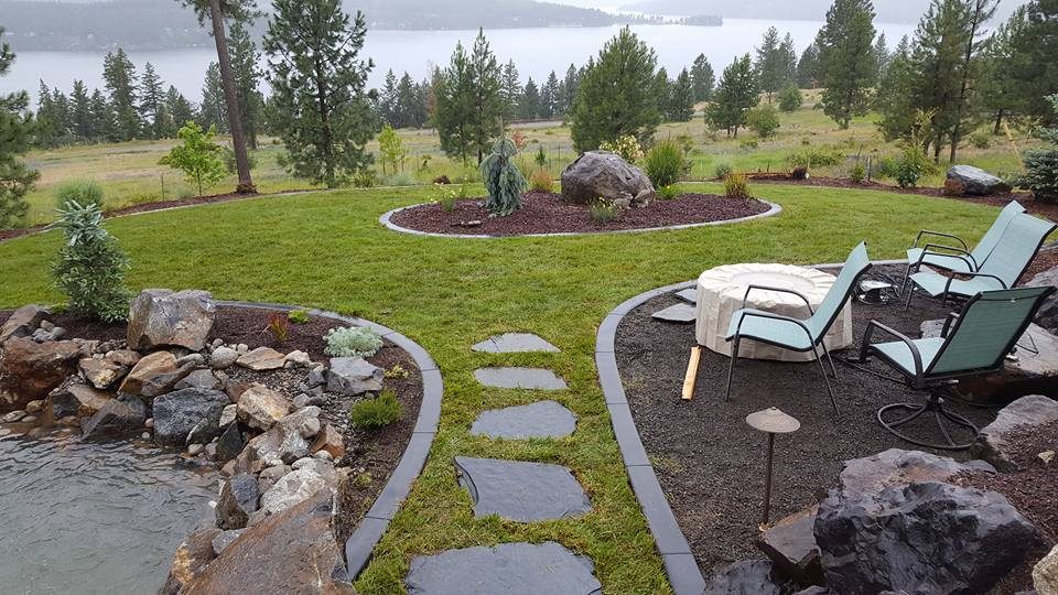 Decorative concrete curbing edging beds in a Spokane yard
