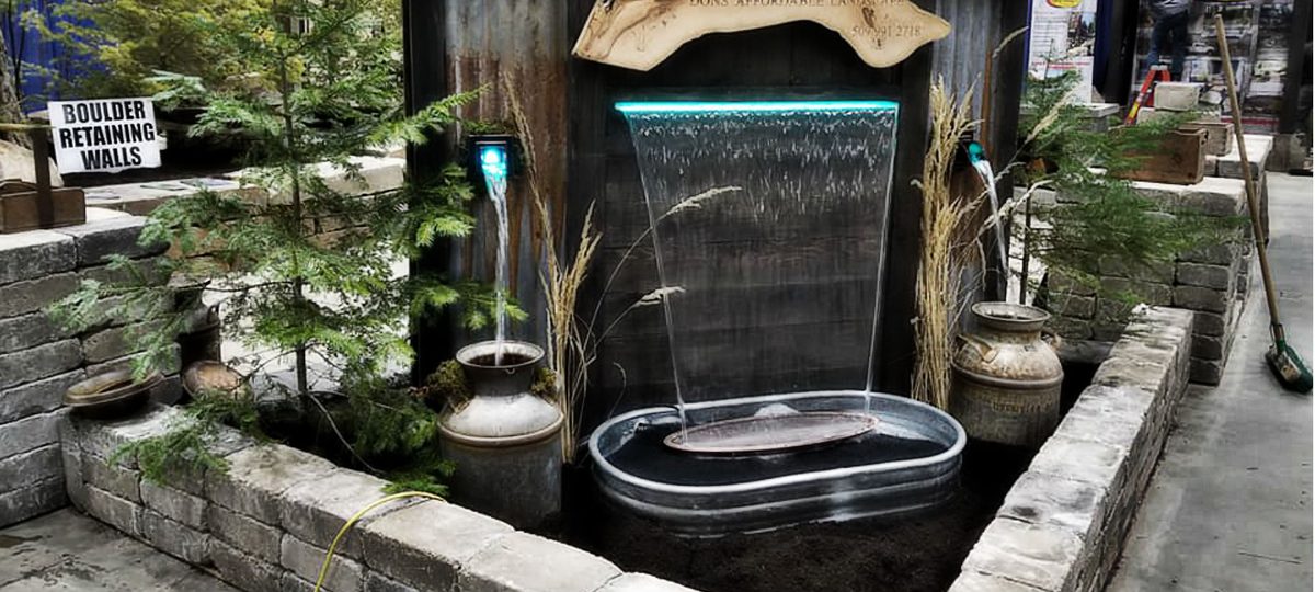 Custom water feature with waterfall in a Spokane landscape
